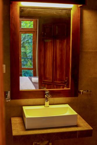 a bathroom with a sink and a mirror and a window at Ayana Resort Wilpattu in Wilpattu