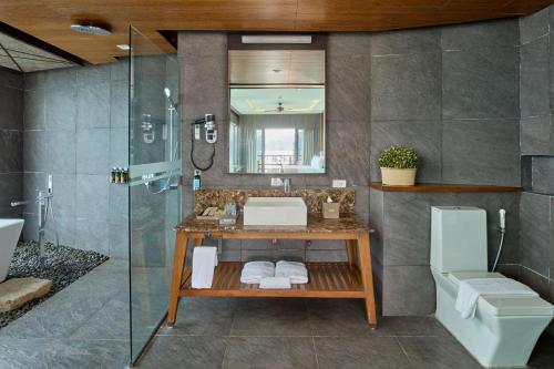 a bathroom with a sink and a shower at Two Seasons Coron Bayside Hotel in Coron