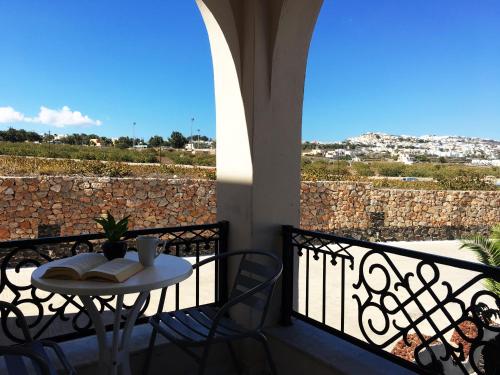 a table and chairs on a balcony with a view at Villa Agas in Karterados