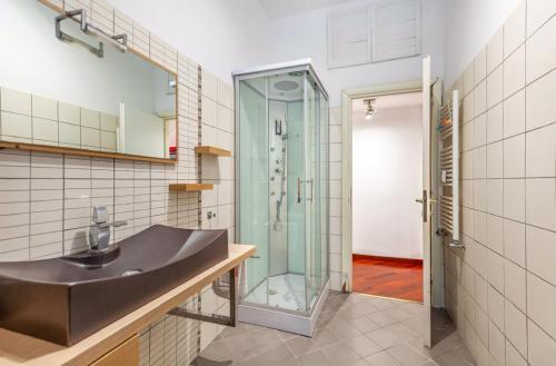 a bathroom with a sink and a glass shower at Vacanze Romane con giardino in Rome