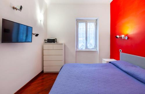a bedroom with a purple bed and a red wall at Vacanze Romane con giardino in Rome