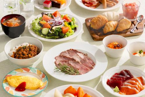 a table topped with plates of food and bowls of food at Akihabara Washington Hotel in Tokyo