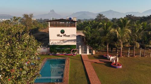 a resort with a swimming pool and a water tower at Raaj Resort in Panvel