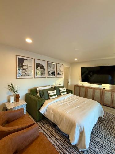 a bedroom with a large bed and a couch at Beach Paradise- 4 Min Walk To Beach in Santa Cruz