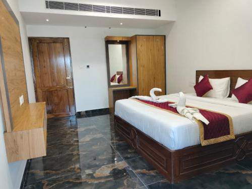 a bedroom with two beds in a room at VGN Convention Centre in Vāniyambādi