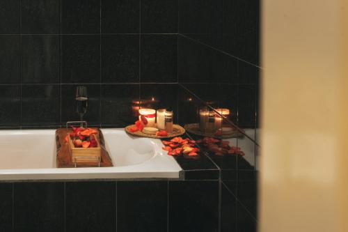 a bathroom with a bath tub with candles in it at Nostalgia Villa Dalat in Ấp Ða Lợi