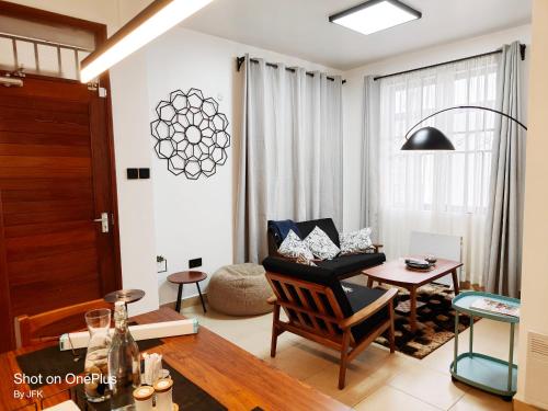 a living room with a chair and a table at Twiga Luxe in Arusha
