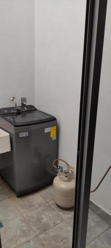 a toilet sitting in a room next to a wall at Kahjú Arandas Depa in Arandas