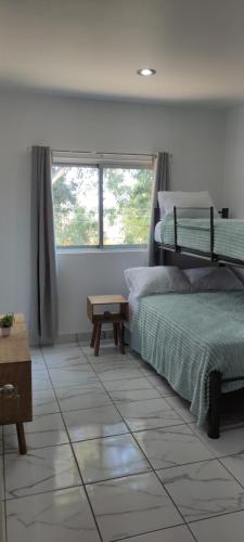 a bedroom with two bunk beds and a window at Kahjú Arandas Depa in Arandas