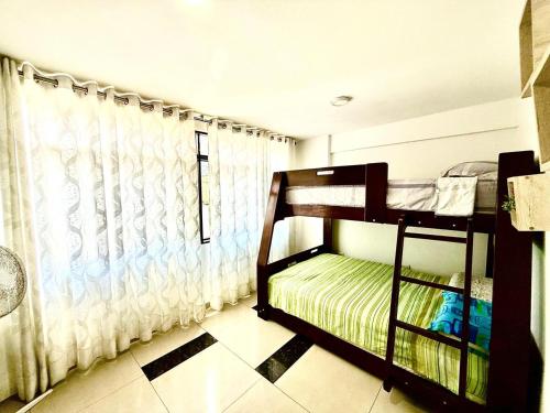 a bedroom with two bunk beds and a window at Comfort House in Lima