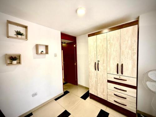 a bathroom with a large cabinet and a tiled floor at Comfort House in Lima