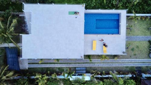 an overhead view of a house with a swimming pool at Trika Surfcamp Bali in Airsatang