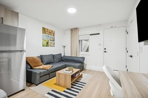 a living room with a couch and a table at NEST- Modern 2BR Basement Retreat in South Surrey in Surrey