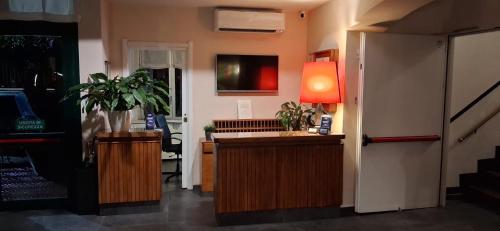 a room with a desk with a lamp and plants at Hotel La Capannina in Genoa