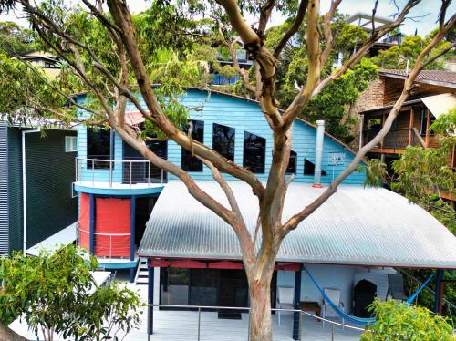 a blue building with a tree in front of it at Copacabana Fab & Funky in Copacabana