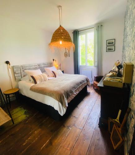 a bedroom with a large bed and a window at charming guest house in Bolbec