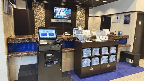 a store with a cash counter with a cash register at Toyoko Inn Tokyo Akigawa-eki Kita-guchi in Akiruno