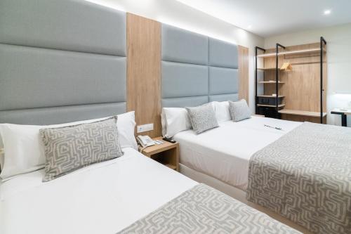 Llit o llits en una habitació de Hotel Selu