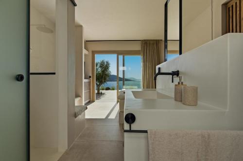 a kitchen with a sink and a view of the ocean at Villa Noema in Agiassos