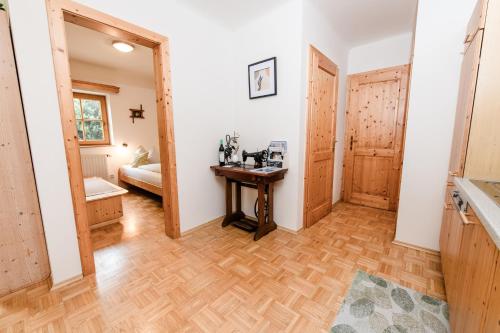 a room with a wooden table and a bedroom at Weingut Dietl in Riegersburg