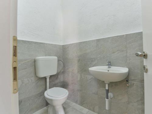 a bathroom with a toilet and a sink at Marinic Comfortable holiday residence in Zadar