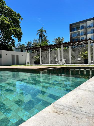 a swimming pool in front of a building at Family Vacations Incredible Beach and Pool in Boca del Río