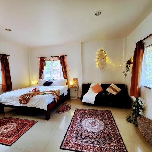 a bedroom with two beds and a couch at Beach Path in Haad Chao Phao