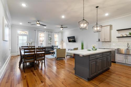 a kitchen and living room with a table and chairs at Stunning 4BR-5BR near French Quarter Homes by Hosteeva in New Orleans