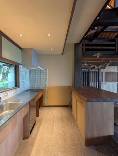 a large kitchen with a sink and a counter at Yamanoto in Toyooka
