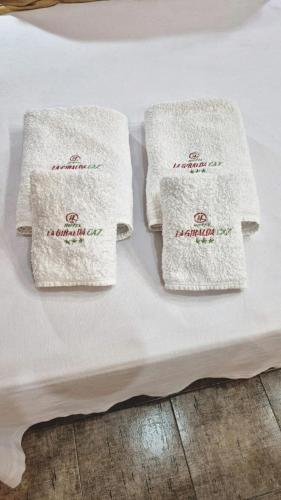 two white towels sitting on top of a bed at Hotel La Giralda CAZ in Vera