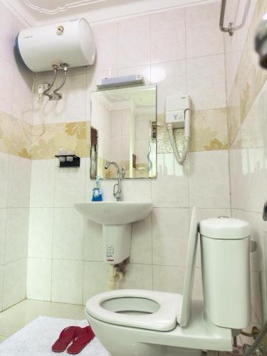 a bathroom with a toilet and a sink at Elite properties in Kampala