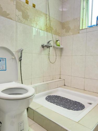 a bathroom with a shower with a toilet and a shower at Elite properties in Kampala
