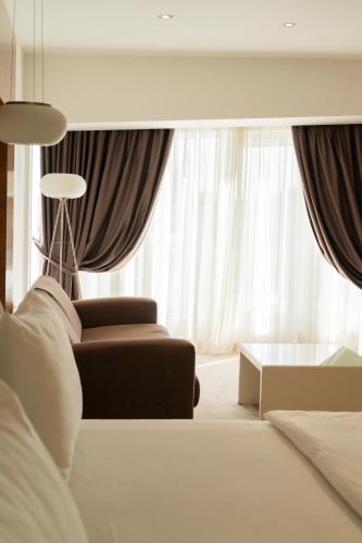 a living room with a couch and a table at Garni Hotel Centar in Novi Sad