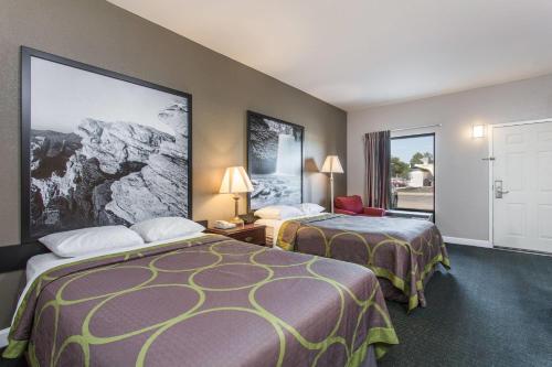 a hotel room with two beds and a window at Super 8 by Wyndham Petersburg in Petersburg
