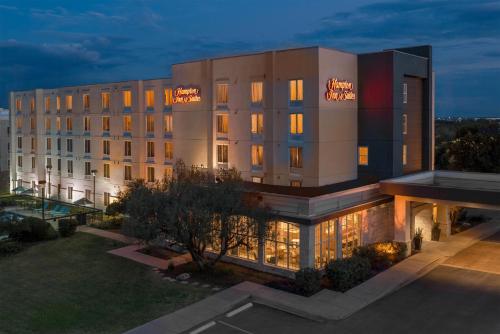 a large building with lights on the side of it at Hampton Inn & Suites-Austin Airport in Austin