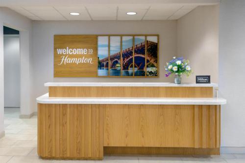 a welcome desk in a lobby with a bridge at Hampton Inn & Suites-Austin Airport in Austin
