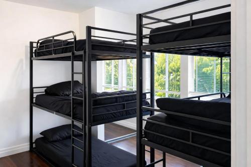 a room with four bunk beds in a room at Vernon Homes For The Soul in Los Angeles