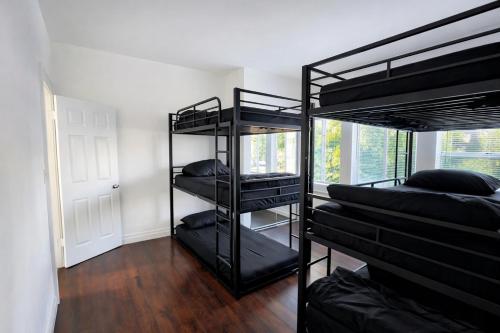 a room with three bunk beds and a window at Vernon Homes For The Soul in Los Angeles