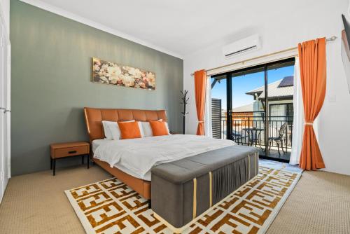 a bedroom with a bed and a large window at Equitice Autumn Moonlight Villa in Perth