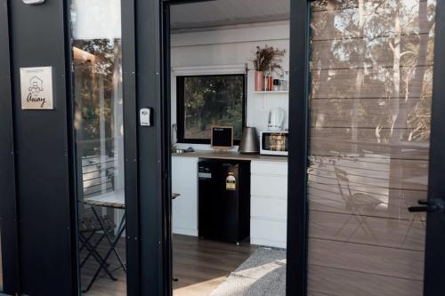 a door leading into a kitchen with a counter at Tiny Tamborine 2 by Tiny Away in Wongawallan