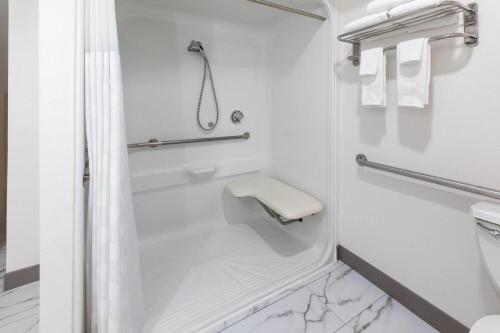 a bathroom with a shower and a toilet at Howard Johnson by Wyndham Malden Boston Area in Malden