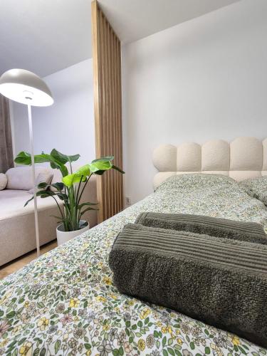 a bedroom with a bed with a plant on it at Apartmán Sárka Brezno in Brezno