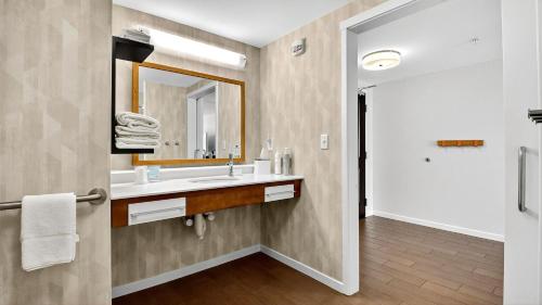 a bathroom with a sink and a mirror at Hampton Inn & Suites Chippewa Falls in Chippewa Falls