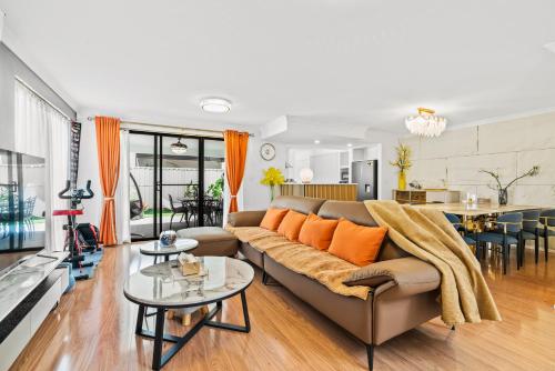 a living room with a couch and a table at Equitice Autumn Moonlight Villa in Perth