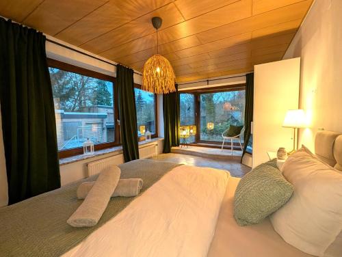 a bedroom with a large bed with a large window at Heidezimmer in Bispingen