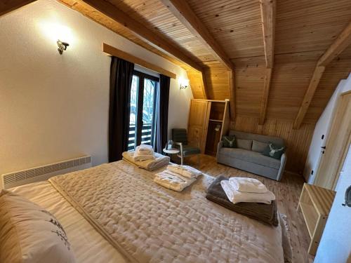 a bedroom with a large bed with towels on it at Mountain Chalet & Spa Makov Hrib in Makov Hrib