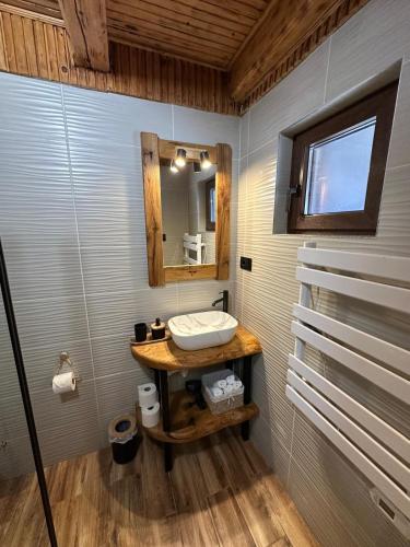 a bathroom with a sink and a mirror at Mountain Chalet & Spa Makov Hrib in Makov Hrib