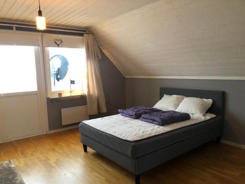 a bedroom with a bed and a large window at Villa Tina in Hammarstrand
