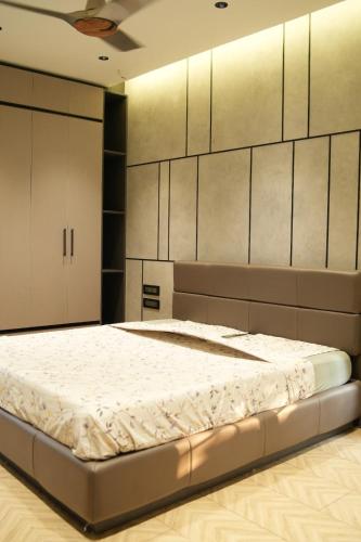 a bedroom with a large bed in a room at Sharvin Villa in Karaikal