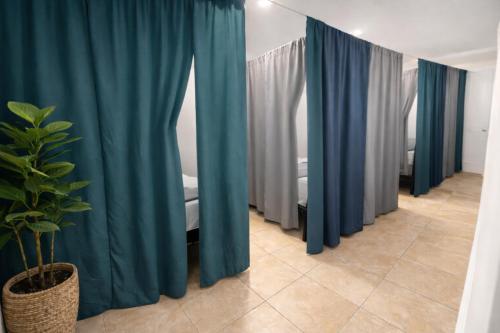 a row of blue curtains in a room at Santa Ana Love Home in Santa Ana